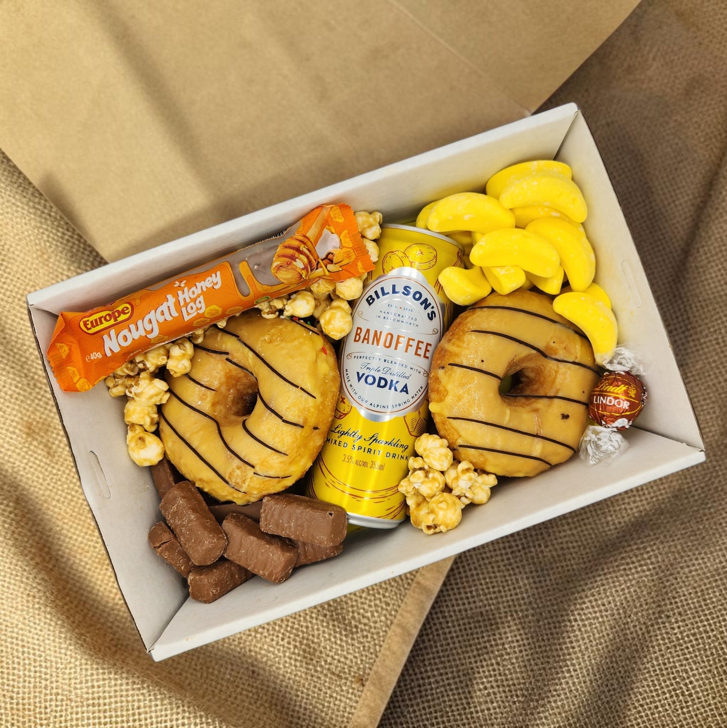 Donut Bouquet Canberra Banoffee Pie Vodka Donut Box with chocolate banana donuts, vodka, nougat, and lollies.