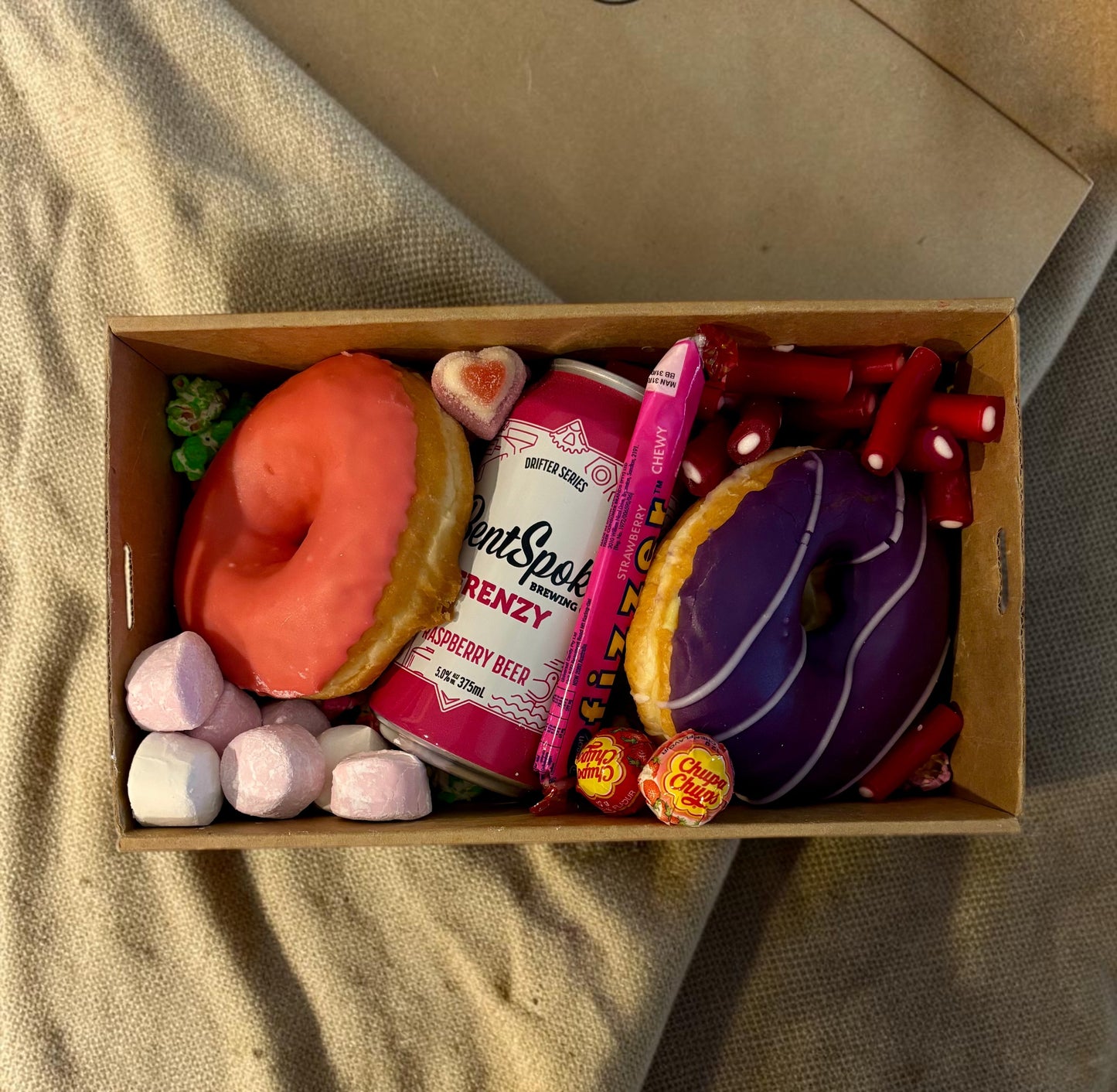 Donut Bouquet Canberra Berry Beer Box with mixed berry and strawberry donuts, raspberry beer, and assorted lollies.