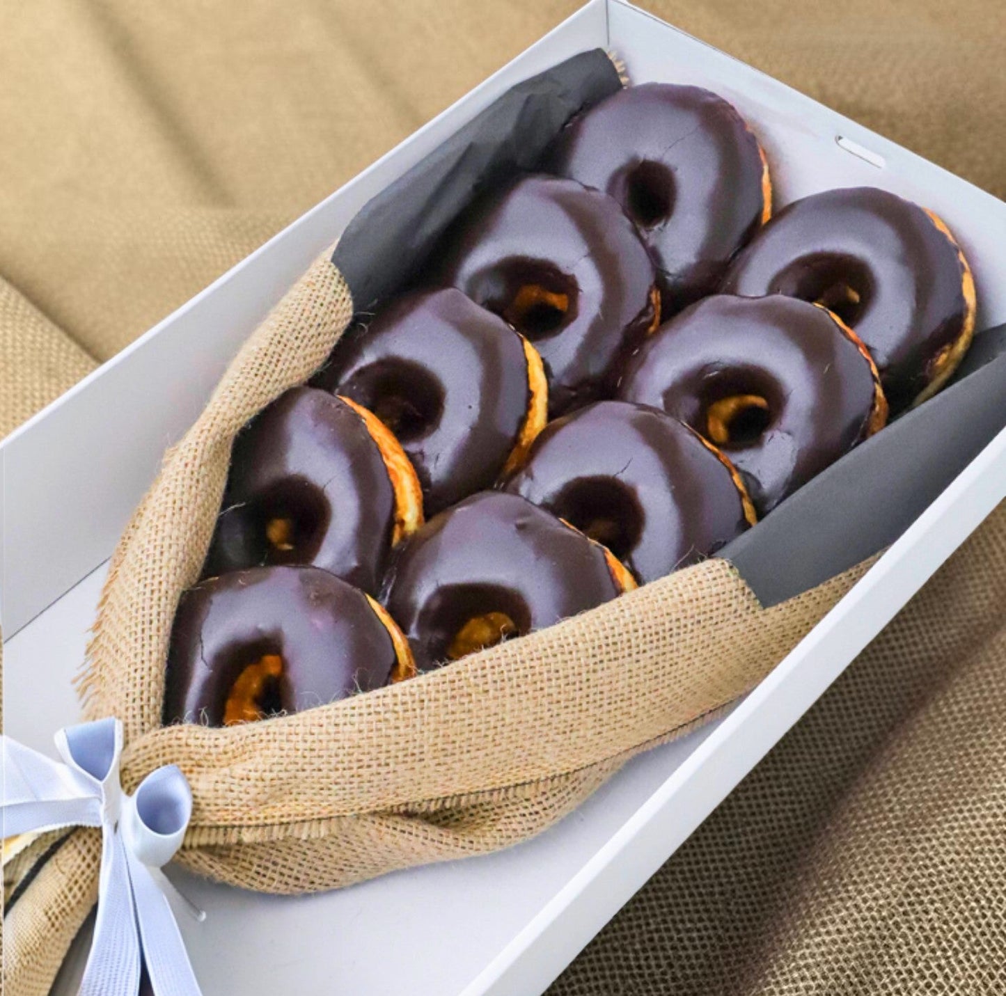 Donut Bouquet Canberra Chocolate Dream bouquet featuring nine oversized chocolate-glazed donuts wrapped in burlap.