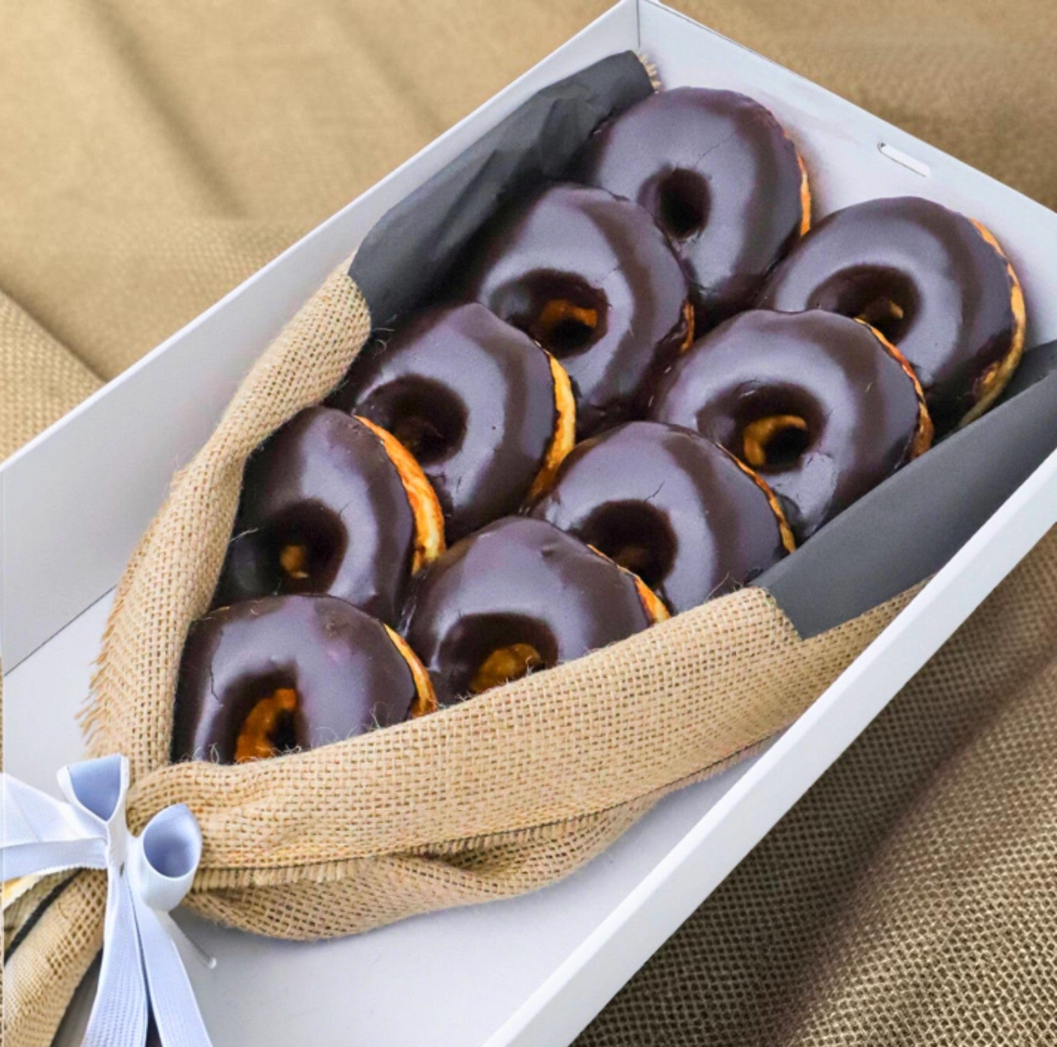 Donut Bouquet Canberra Chocolate Dream bouquet featuring nine oversized chocolate-glazed donuts wrapped in burlap.