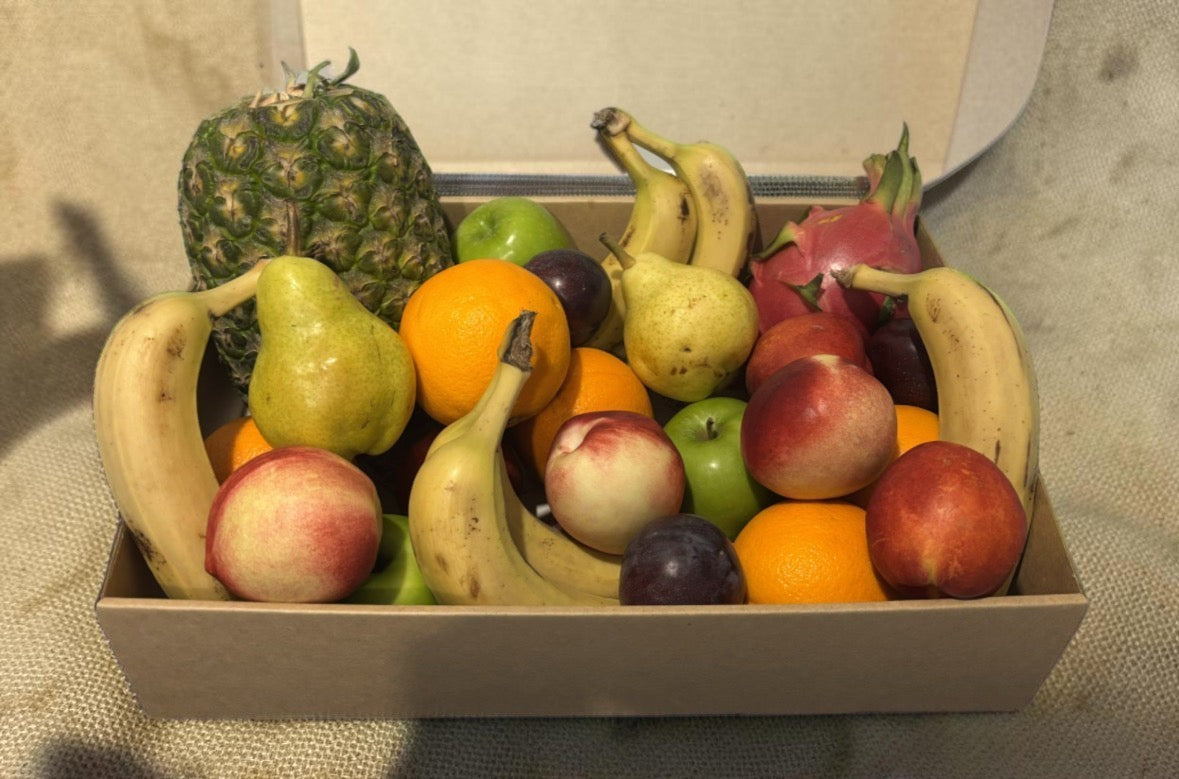 Donut Bouquet Canberra fresh fruit hamper containing a variety of seasonal fruits like pineapple, bananas, and peaches.