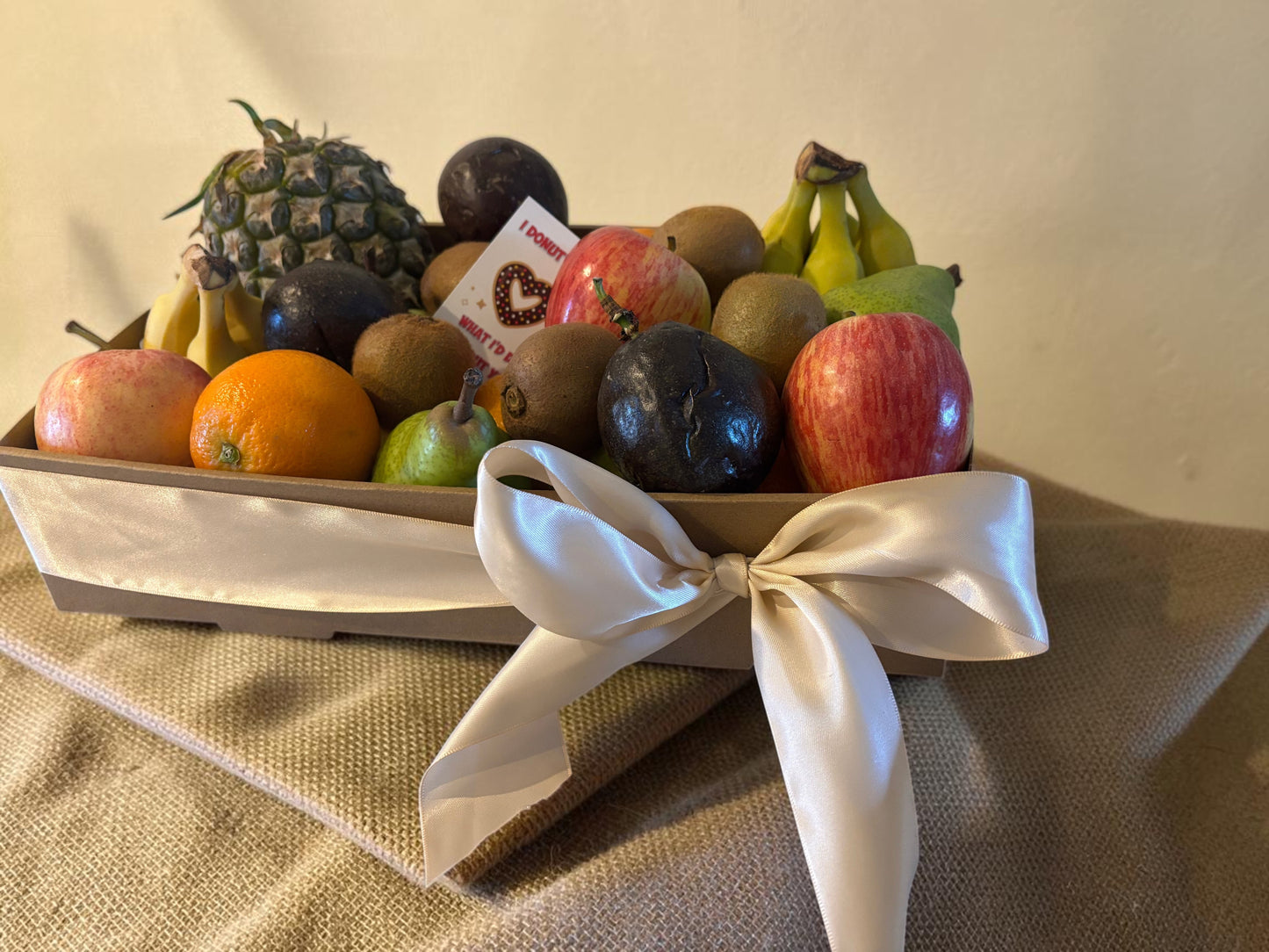 Donut Bouquet Canberra fresh fruit gift hamper featuring assorted seasonal fruits like apples, pears, and pineapple.
