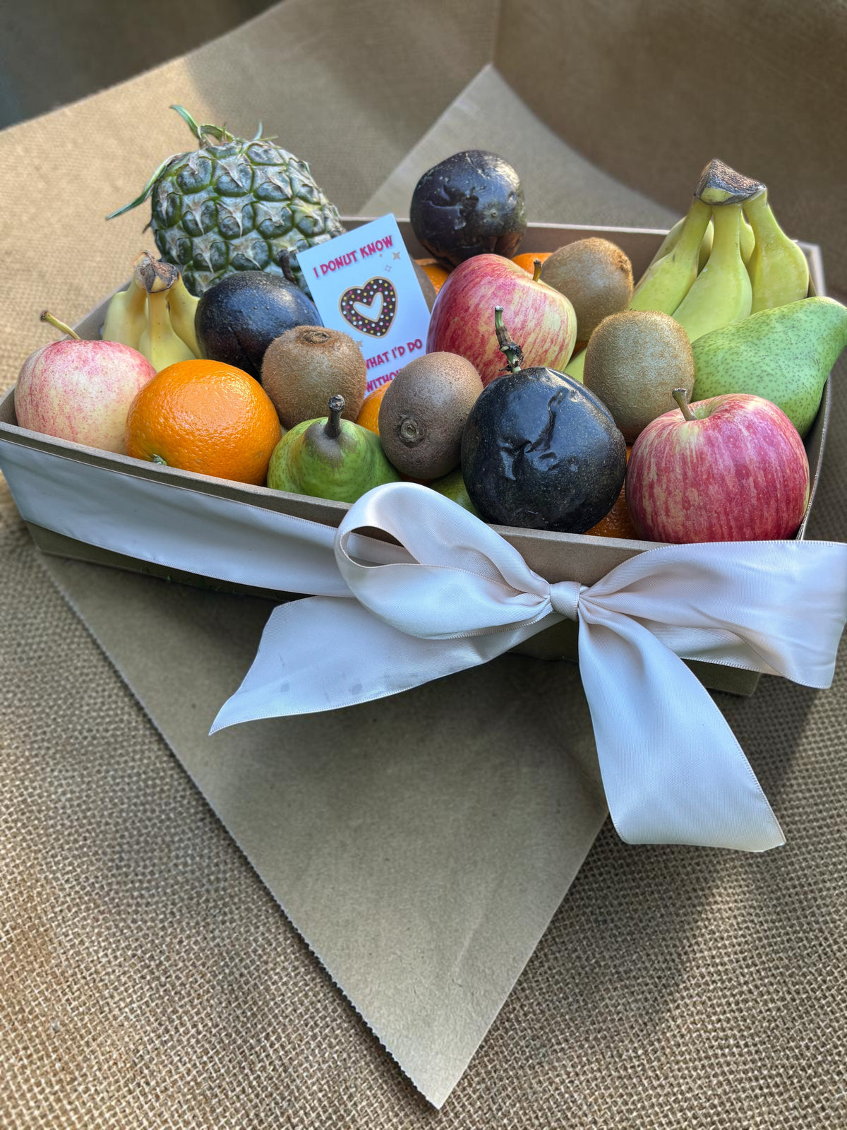 Donut Bouquet Canberra fresh fruit gift hamper featuring assorted seasonal fruits like apples, pears, and pineapple.