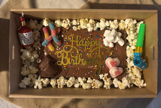Donut Bouquet Canberra gluten free birthday brownie block topped with chocolates, lollies, and popcorn in a gift box.