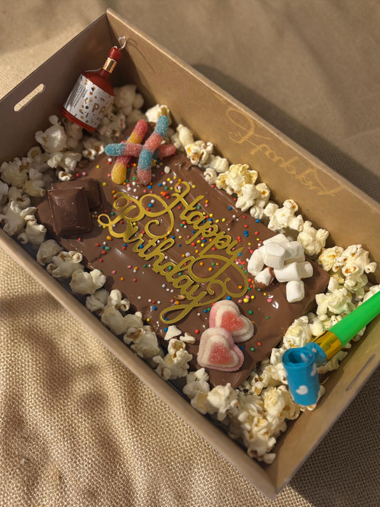 Donut Bouquet Canberra gluten free birthday brownie block topped with popcorn, chocolates, lollies, and sprinkles.