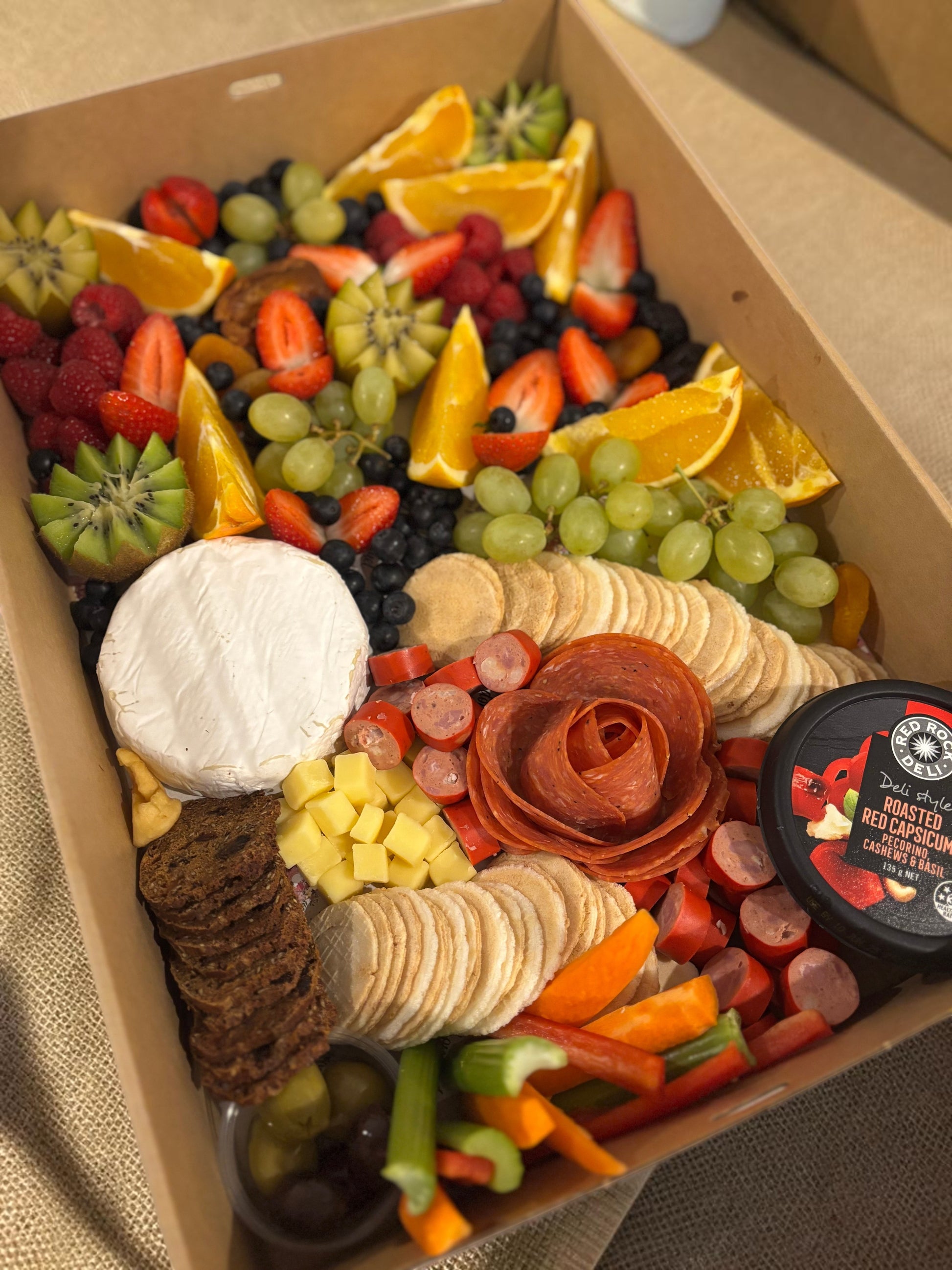Donut Bouquet Canberra grazing box featuring salami rose, assorted cheeses, crackers, fresh fruit, and veggie sticks.