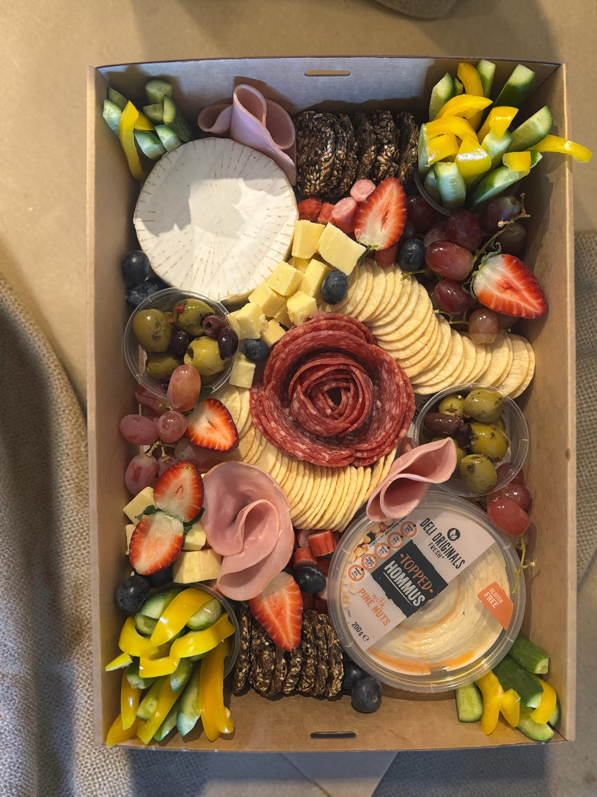 Donut Bouquet Canberra grazing box featuring salami rose, assorted cheeses, crackers, fresh fruit, and veggie sticks.