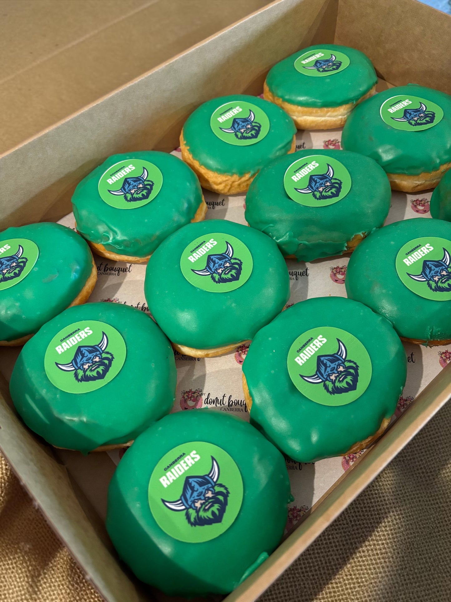 Donut Bouquet Canberra green glazed donuts arranged in rows inside cardboard boxes for a Raiders themed celebration.