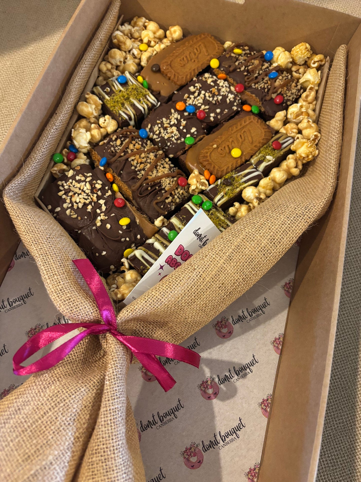 Donut Bouquet Canberra large loaded brownie bouquet gift box with chocolates, popcorn, and M&Ms in a hessian wrap.