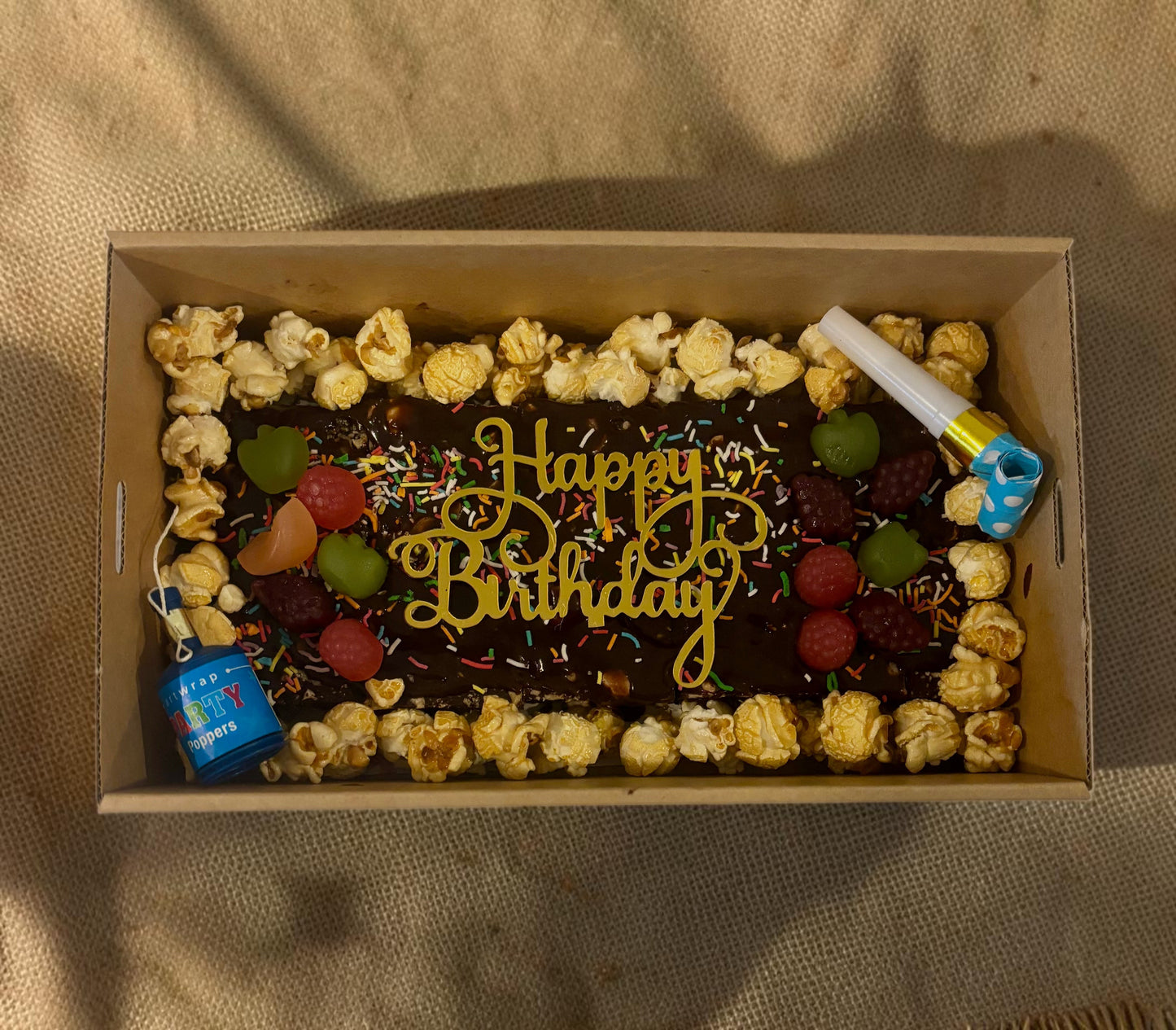 Donut Bouquet Canberra vegan birthday brownie block topped with chocolate, popcorn, lollies, and Happy Birthday sign