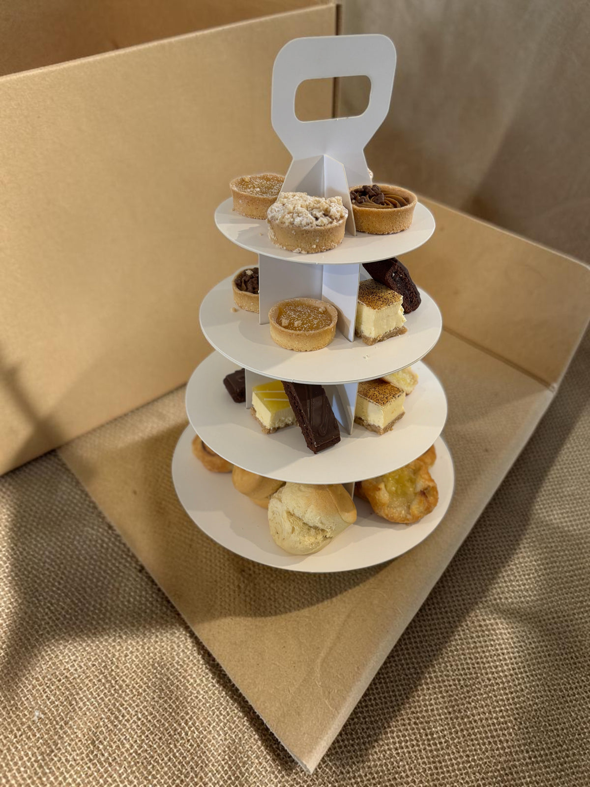 Donut Bouquet Canberra vegan high tea set featuring an assortment of gourmet cakes and pastries on a white tiered stand