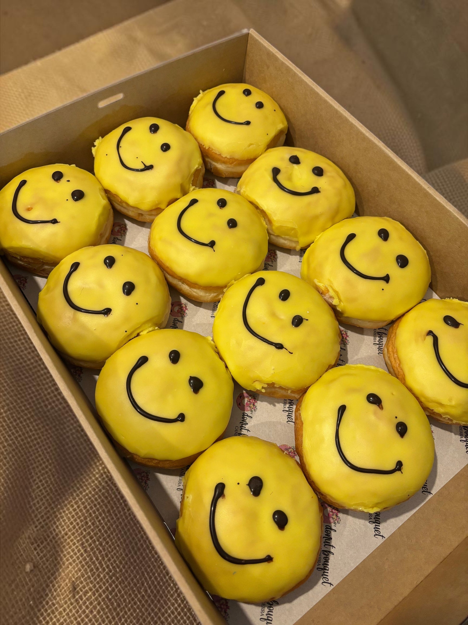 Donut Bouquet Canberra box of yellow smiley face donuts for R U OK Day with chocolate icing smiles